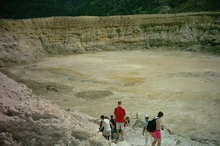 People walking into the volcanic crater of Nisyros Volcano