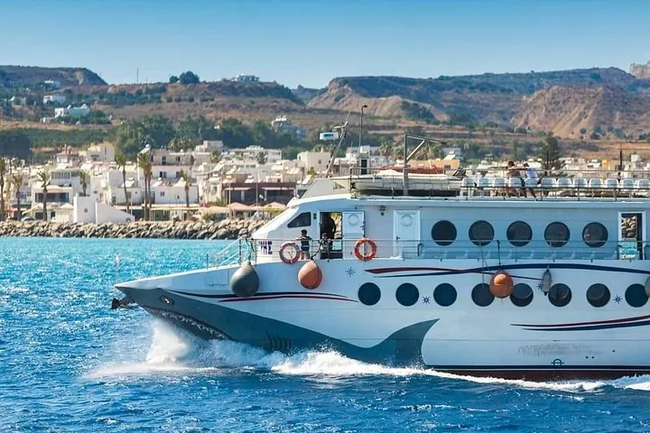 A tour boat passing by a coastal village